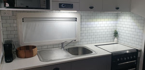 white and grey subway stick on tile in a caravan