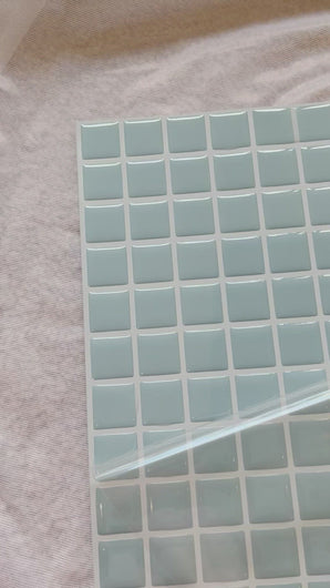 Icy blue square stick on tiles close up