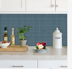 peacock blue stick on tiles in the kitchen as splashback with white cupboards