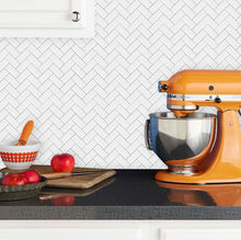 Load image into Gallery viewer, herringbone white and grey peel and stick tile with orange kitchenaid

