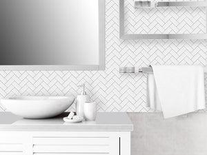 white and grey herringbone peel and stick tile bathroom