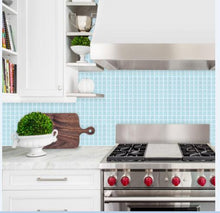Load image into Gallery viewer, Icy blue square peel and stick tile as kitchen splashback behind gas stove, with marble benchtop

