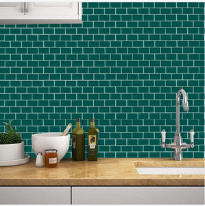 Forest green subway peel and stick tile in the kitchen against an elegant tap