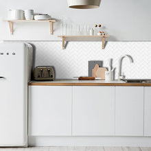 Load image into Gallery viewer, white herringbone peel and stick tile with white grout in a caravan kitchen in australia
